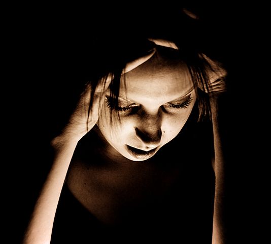 A woman experiencing a migraine headache; photo courtesy Sasha Wolff